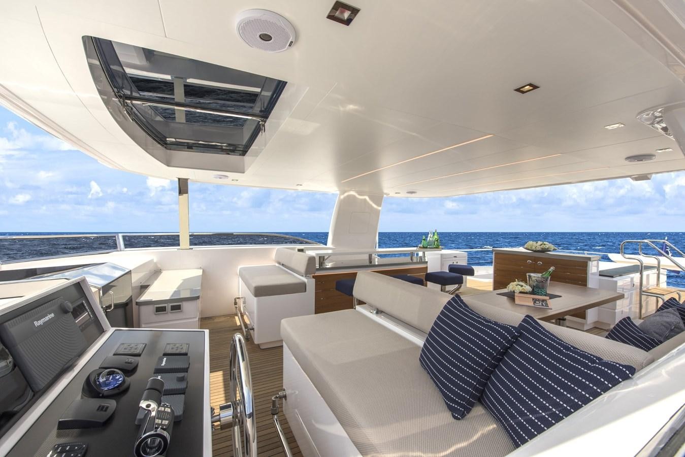 a room with a bed and a table and chairs aboard HORIZON Yacht for Sale