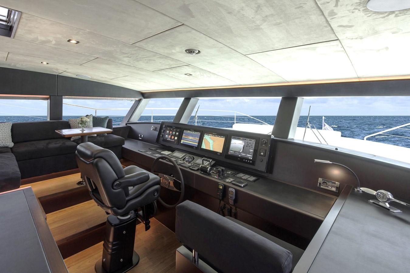 inside of a vehicle with seats and a desk and chairs aboard HORIZON Yacht for Sale