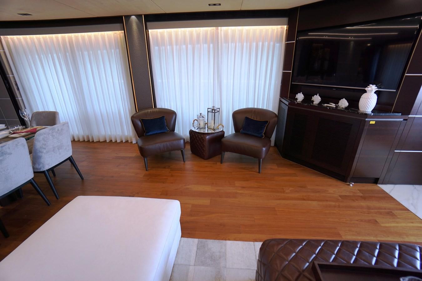 a living room with a tv and furniture aboard HORIZON Yacht for Sale