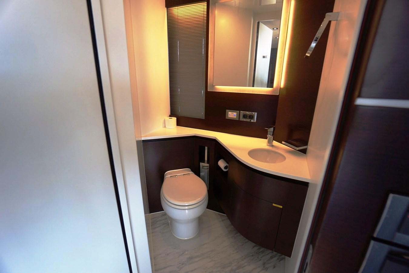a bathroom with a toilet and sink aboard HORIZON Yacht for Sale
