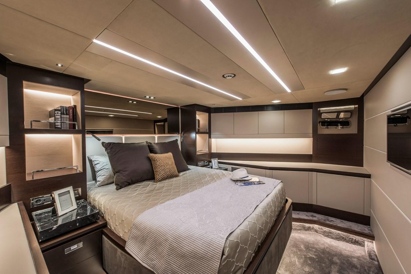 a bedroom with a bed and a desk aboard HORIZON Yacht for Sale