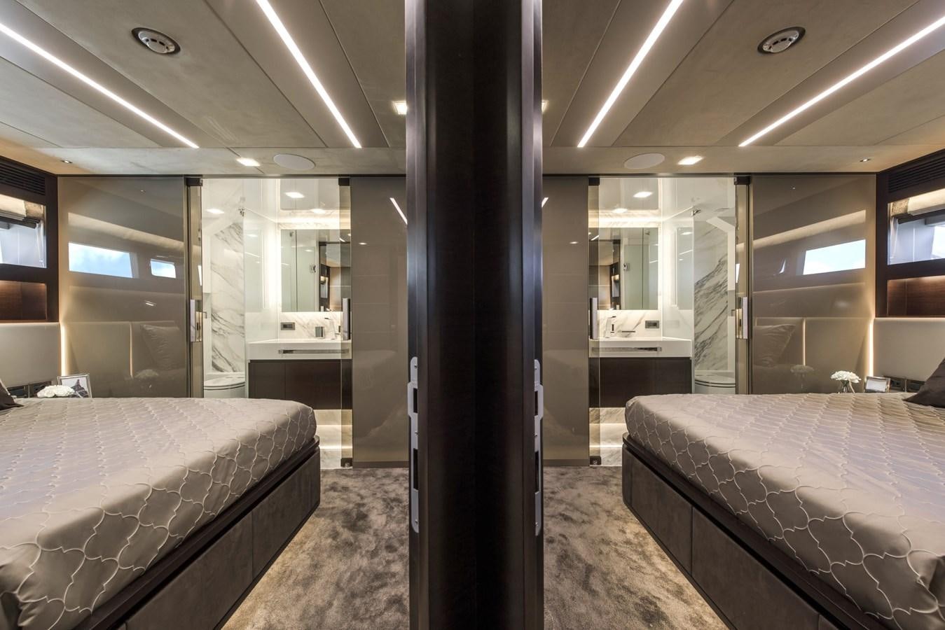 a room with a bed and a mirror aboard HORIZON Yacht for Sale