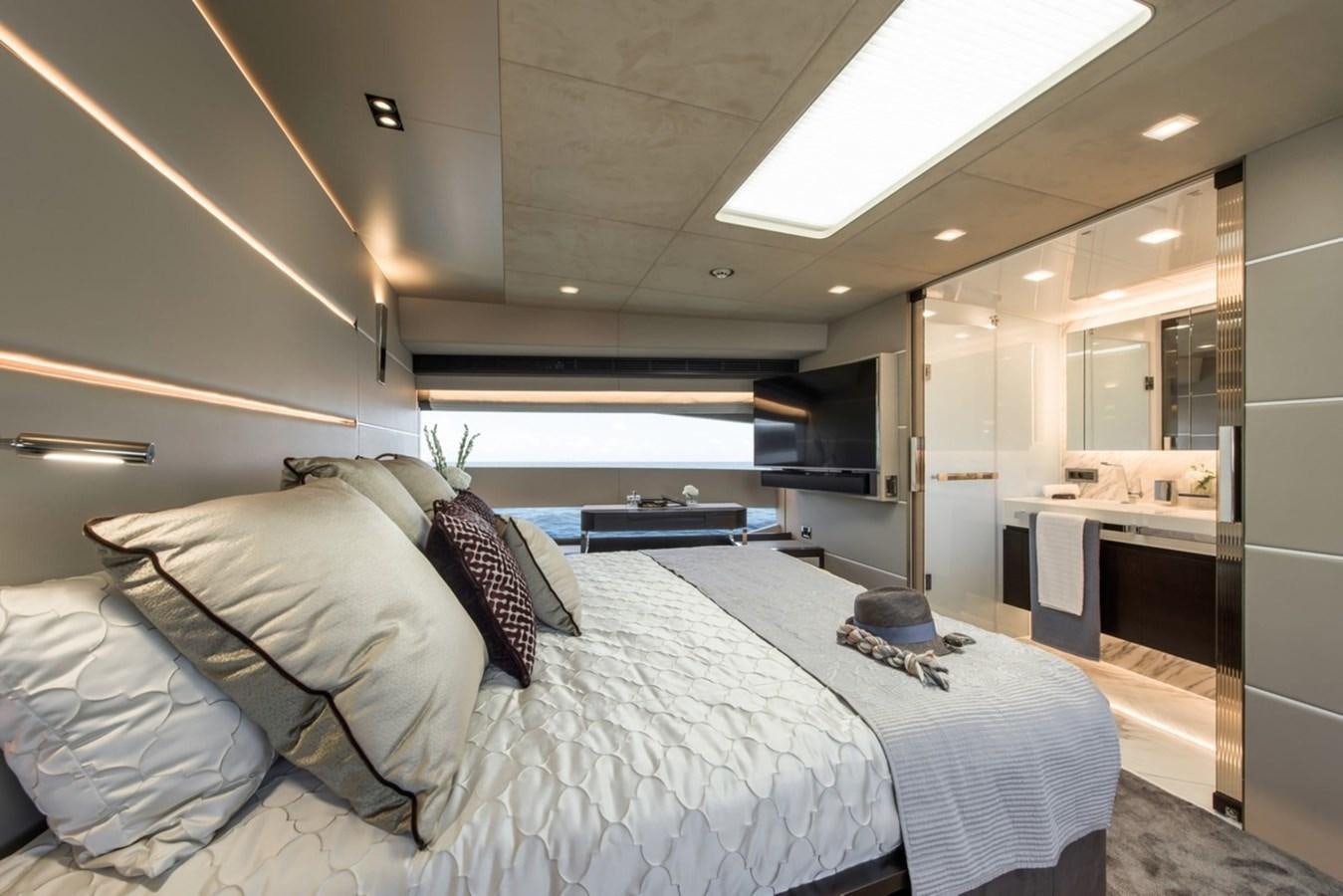 a bedroom with a bed and a desk aboard HORIZON Yacht for Sale