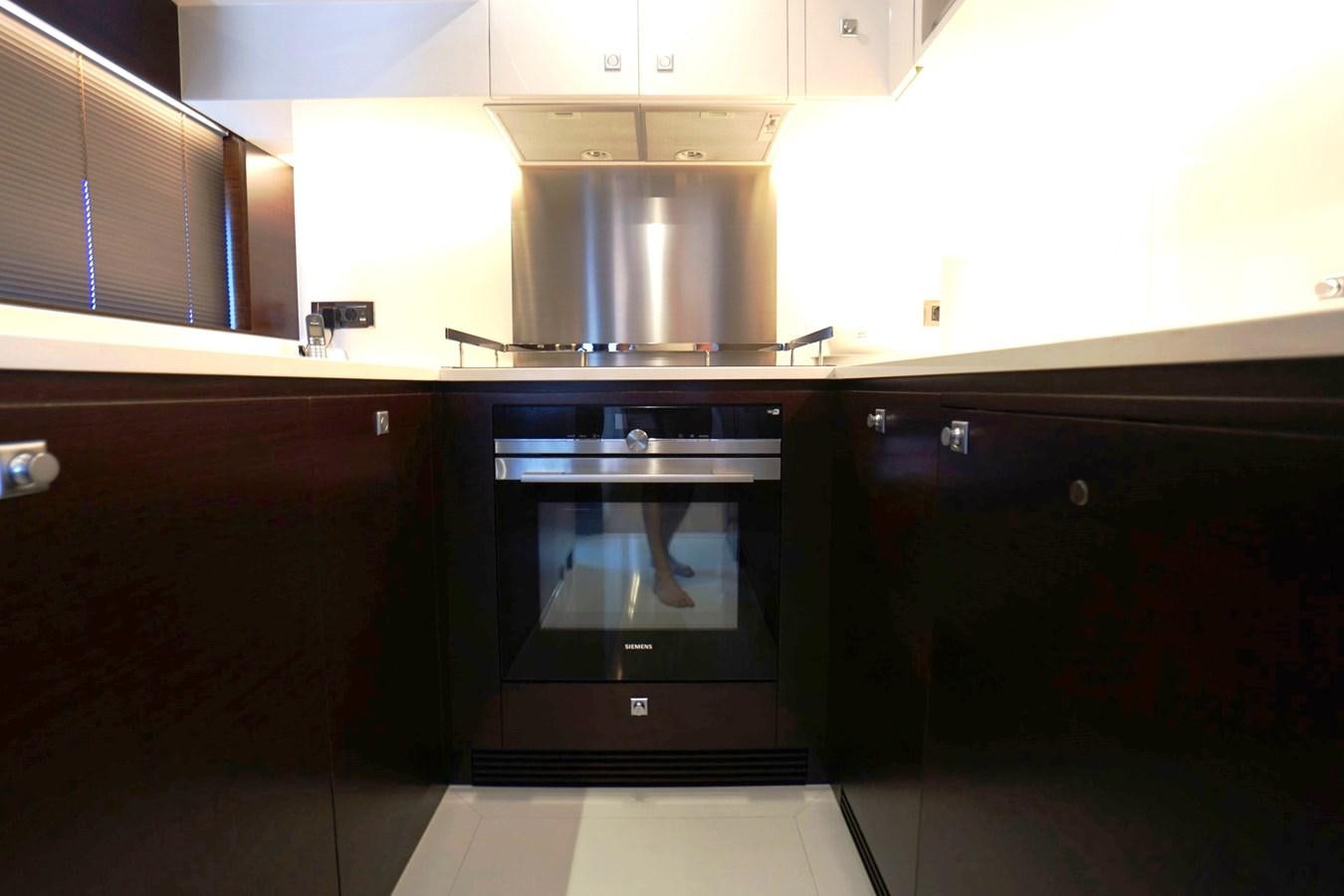 a kitchen with a stove and cabinets aboard HORIZON Yacht for Sale