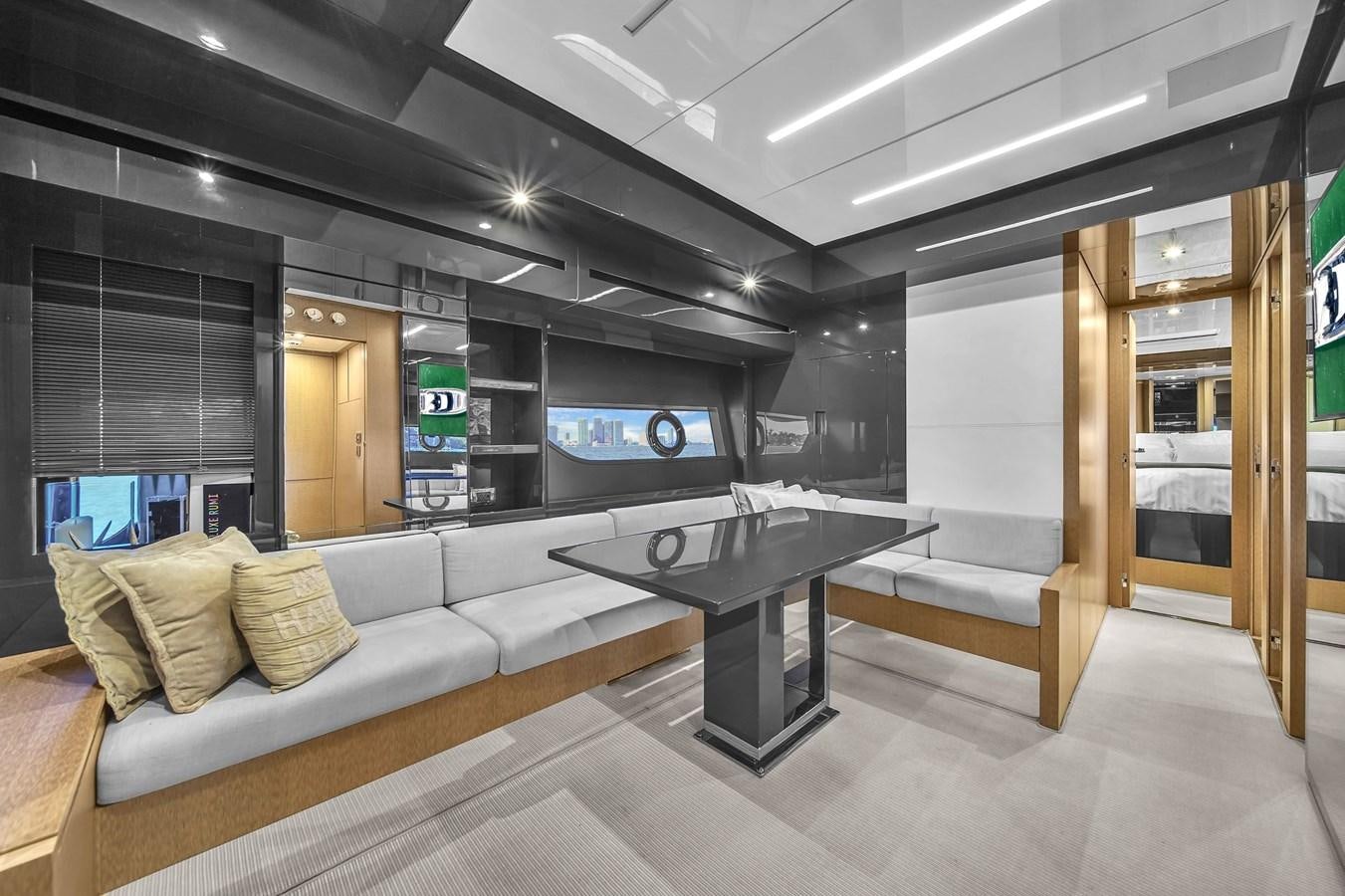 a room with a couch and a table aboard RIVA 76' BAHAMAS Yacht for Sale