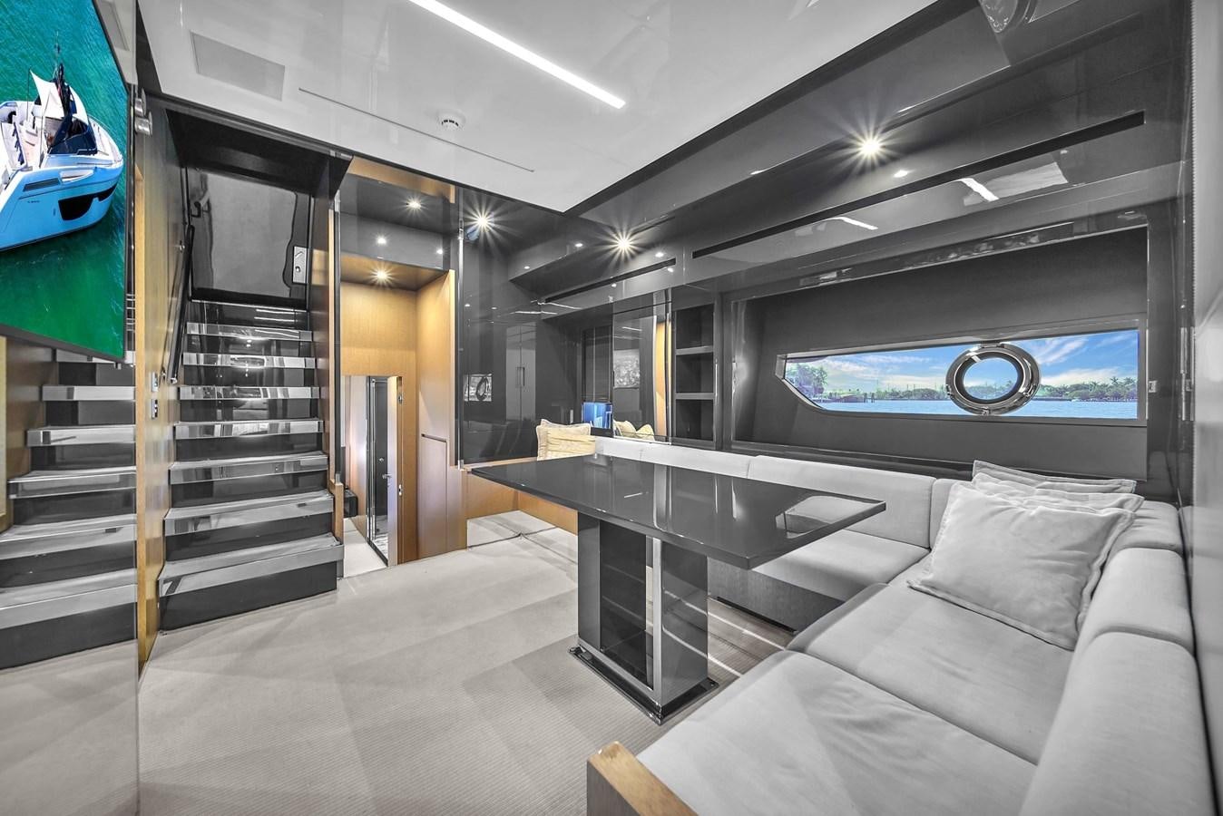 a room with a couch and a television aboard RIVA 76' BAHAMAS Yacht for Sale