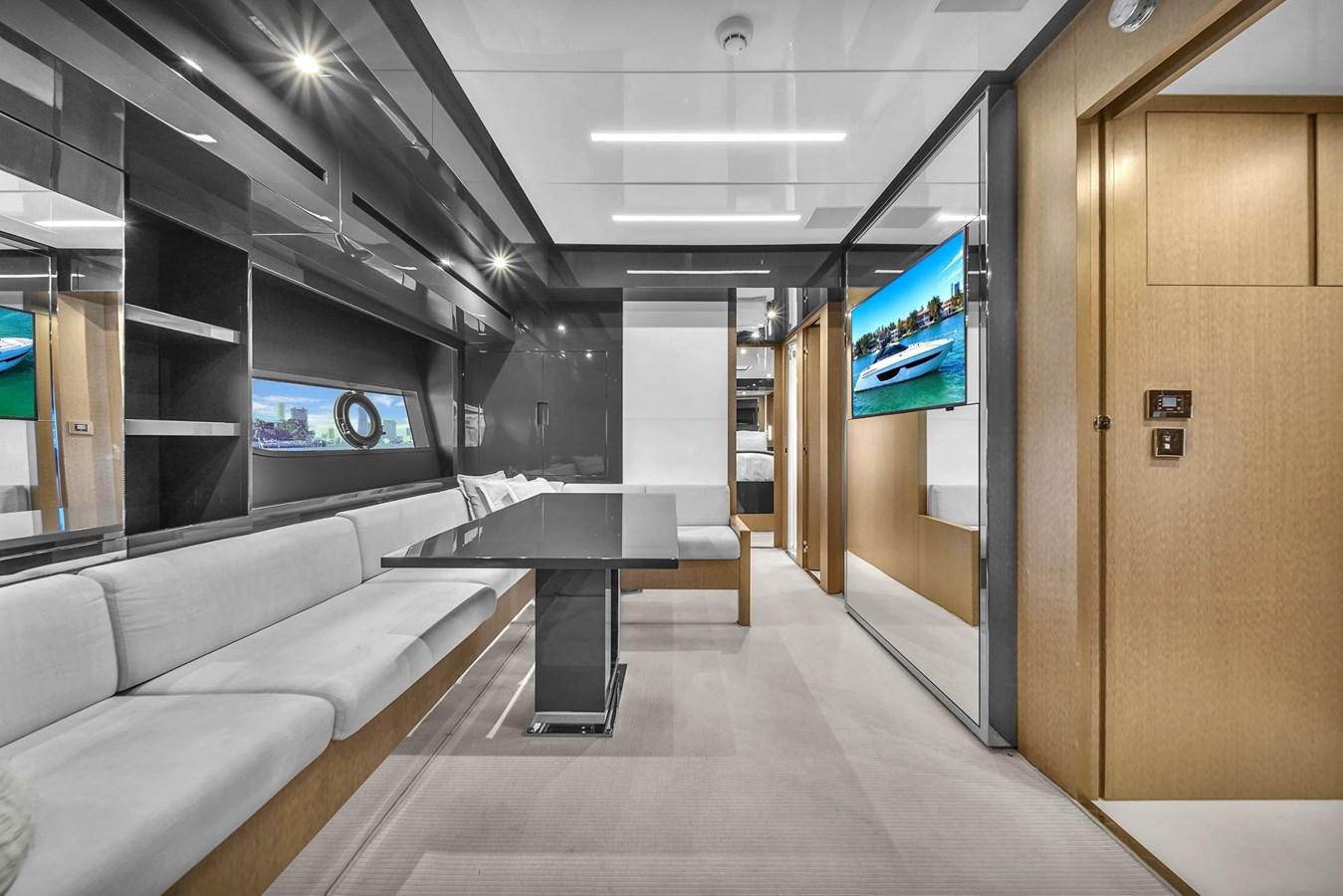 a room with a couch and a tv on the wall aboard RIVA 76' BAHAMAS Yacht for Sale