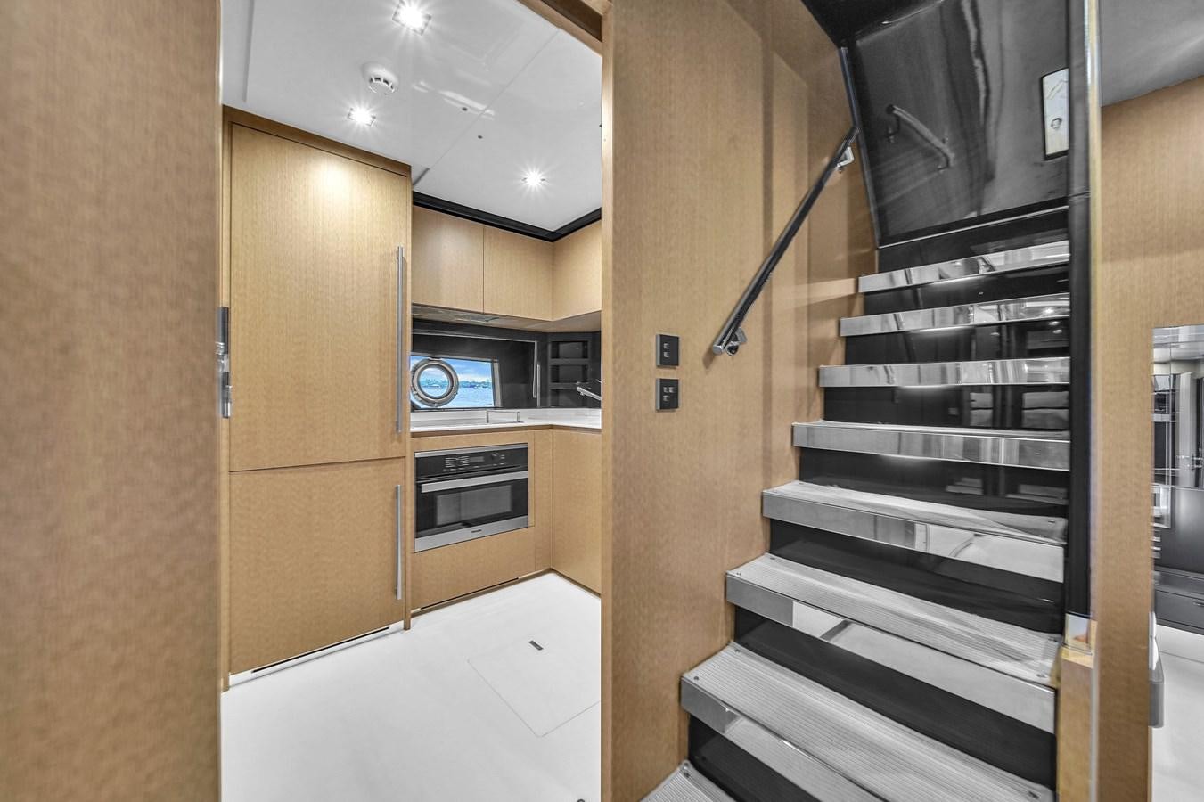 a kitchen with a black stove aboard RIVA 76' BAHAMAS Yacht for Sale