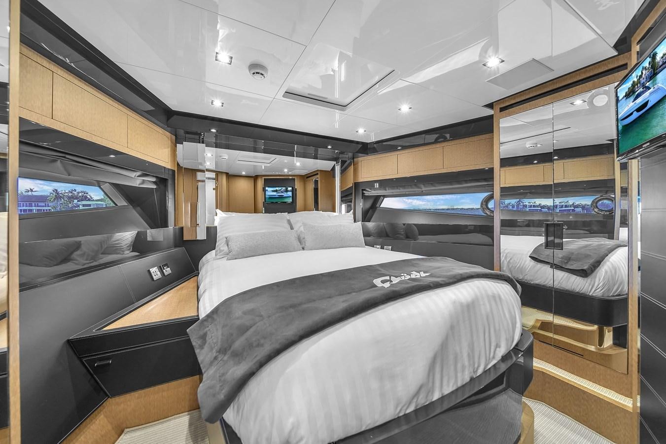 a room with a bed and a tv aboard RIVA 76' BAHAMAS Yacht for Sale