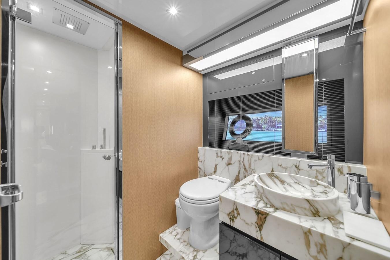 a bathroom with a sink toilet and bathtub aboard RIVA 76' BAHAMAS Yacht for Sale