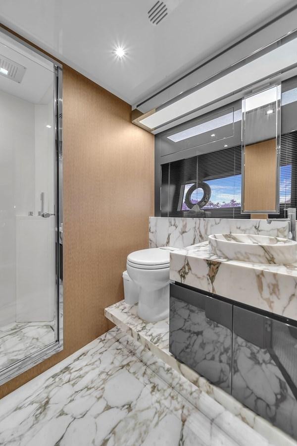 a bathroom with a marble counter top aboard RIVA 76' BAHAMAS Yacht for Sale