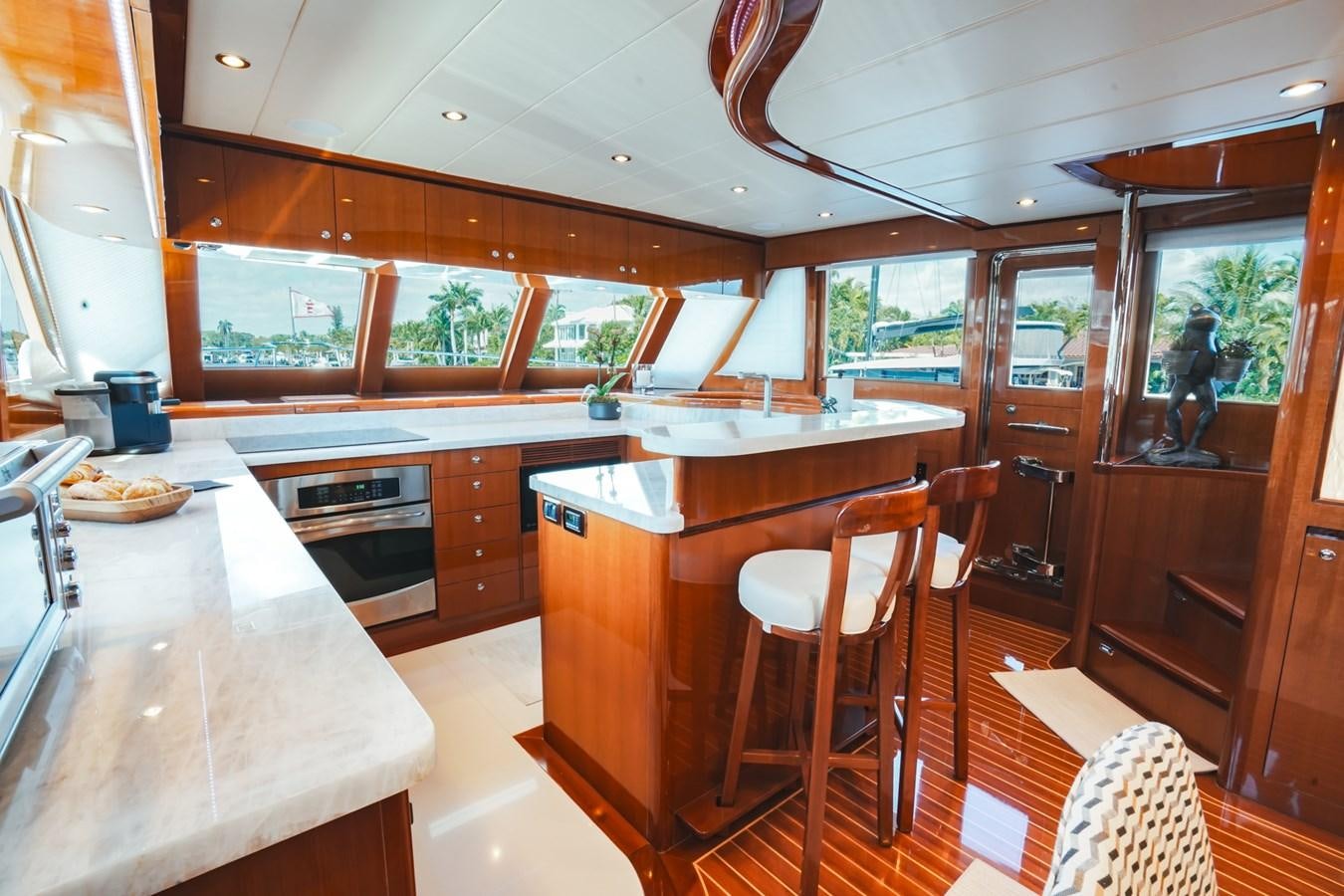 a kitchen with a bar and a table aboard VIAGGIO Yacht for Sale