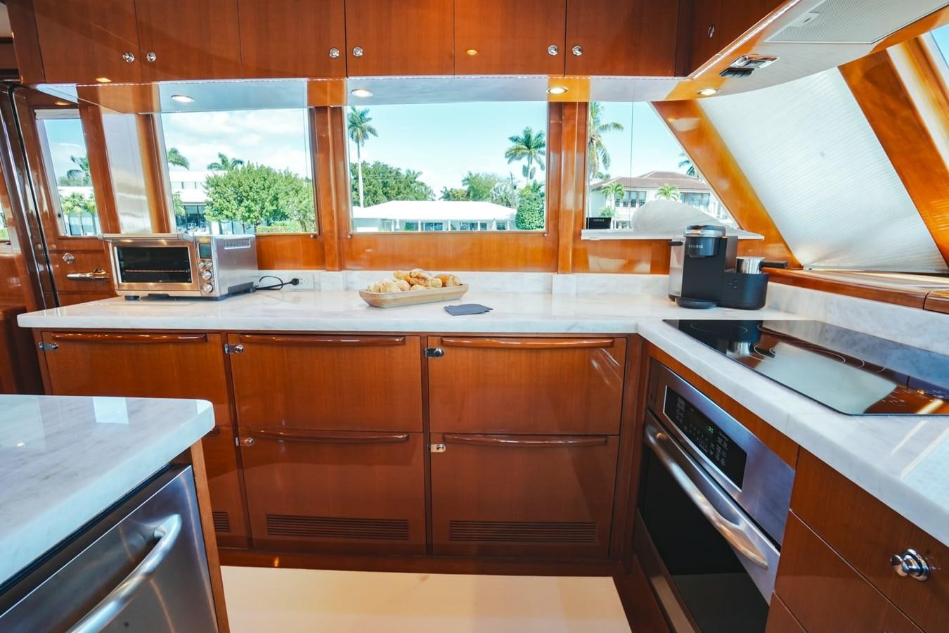 a kitchen with wooden cabinets aboard VIAGGIO Yacht for Sale