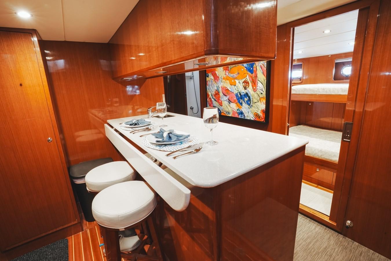 a kitchen with a table and chairs aboard VIAGGIO Yacht for Sale