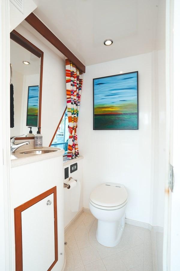a bathroom with a toilet and sink aboard VIAGGIO Yacht for Sale