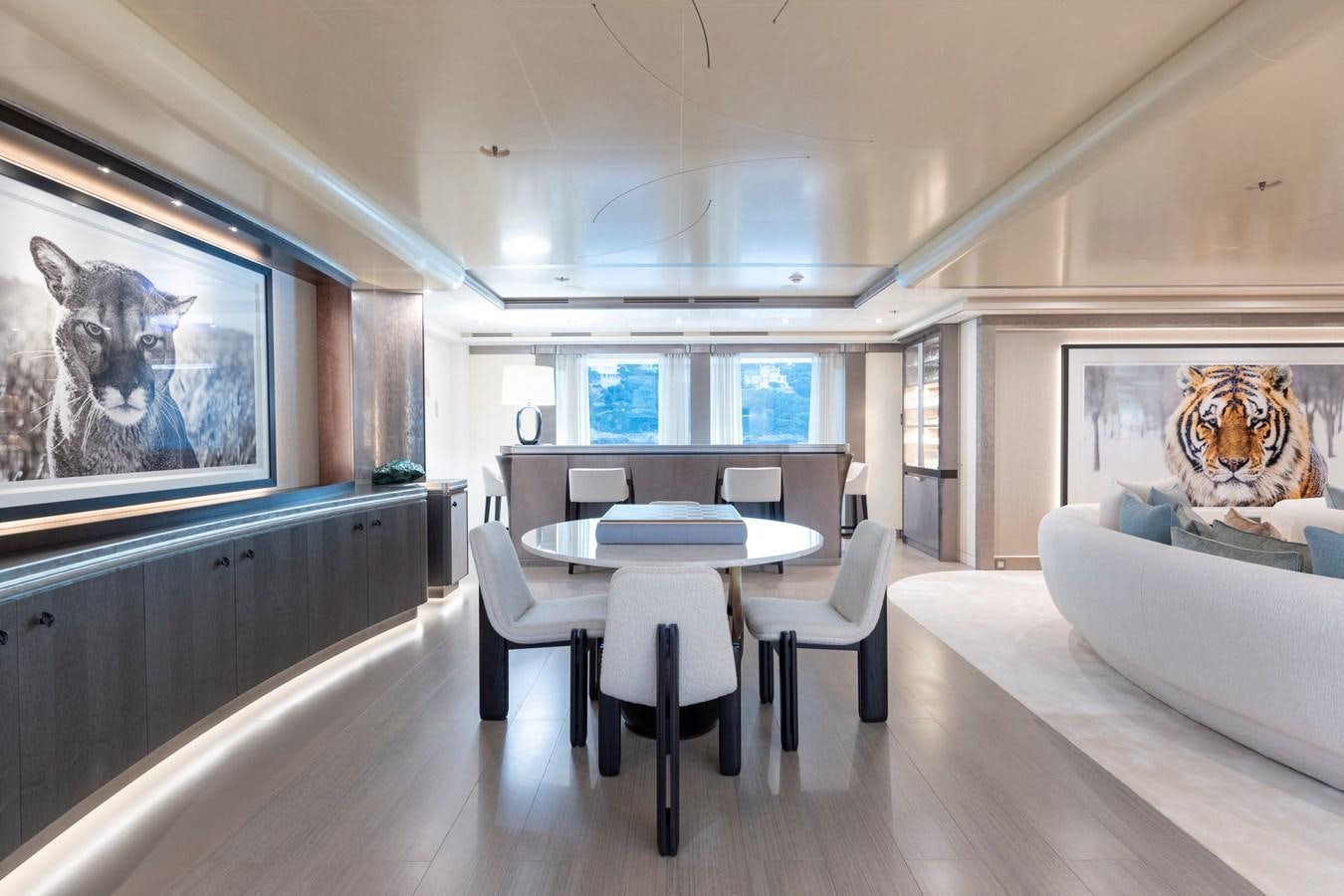 a room with a table and chairs aboard LUNA Yacht for Sale