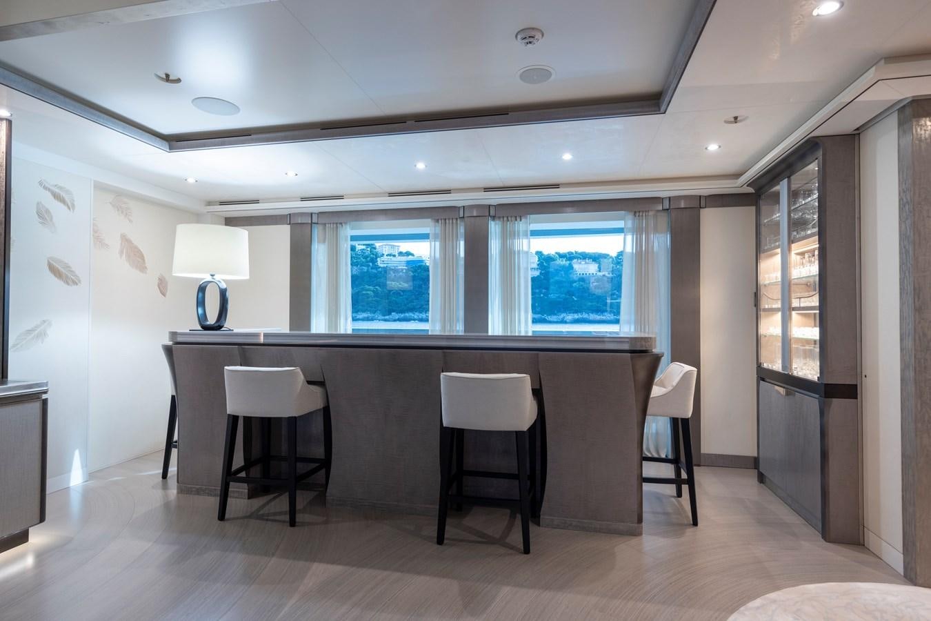 a room with a table and chairs aboard LUNA Yacht for Sale