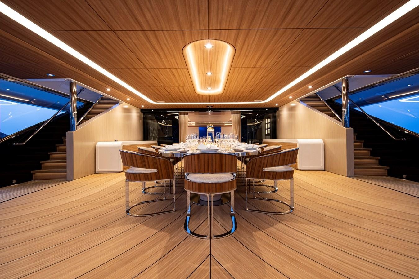 a room with a table and chairs aboard LUNA Yacht for Sale