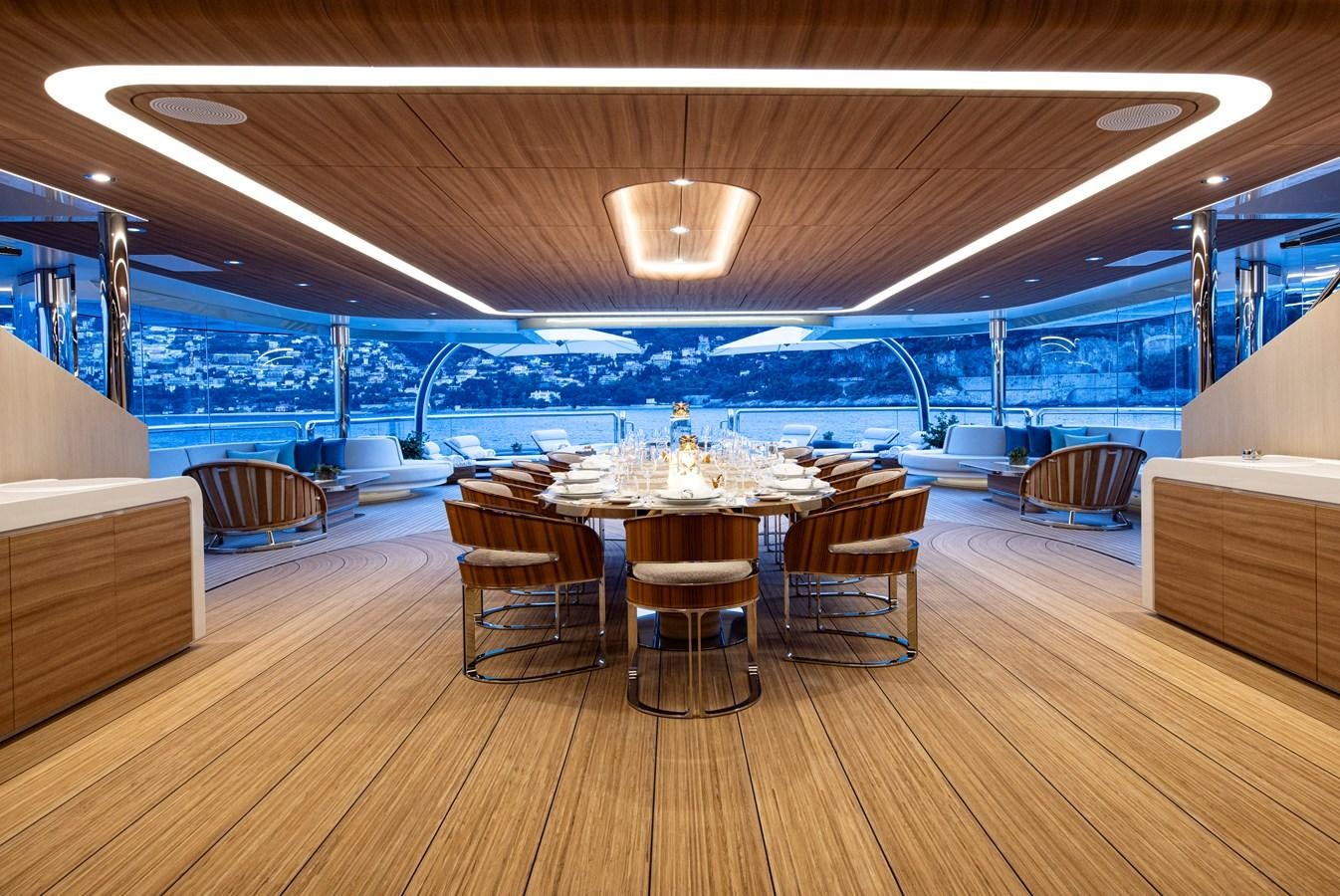 a room with a table and chairs aboard LUNA Yacht for Sale