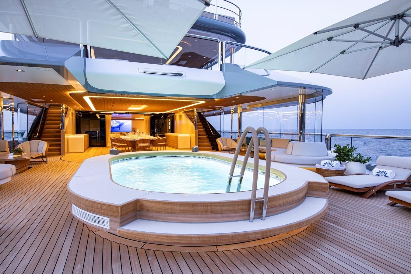 a large lounge area with a pool aboard LUNA Yacht for Sale