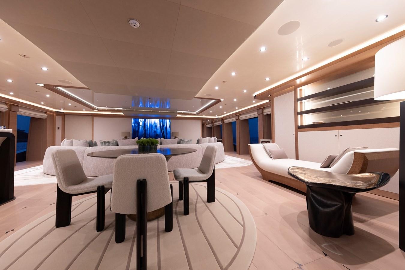 a room with a table and chairs aboard LUNA Yacht for Sale