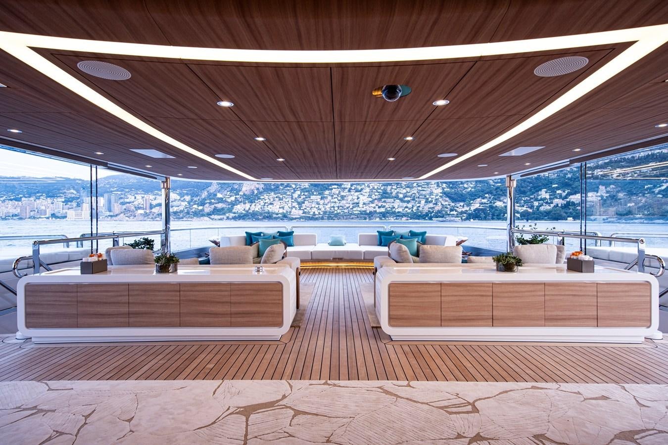 a room with a wood floor and a large window with a view of the ocean aboard LUNA Yacht for Sale