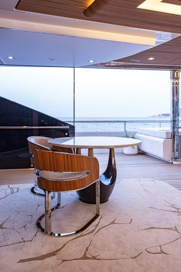 a table and chairs in a room aboard LUNA Yacht for Sale