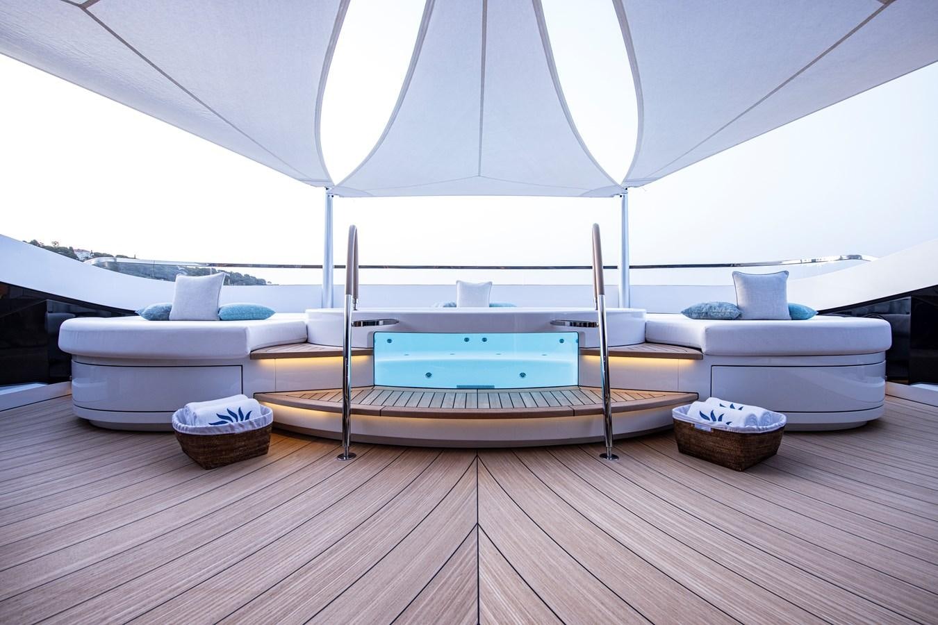 a room with a bed and a table with a white tent aboard LUNA Yacht for Sale
