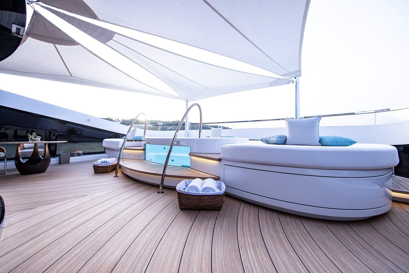 a room with a bed and a table aboard LUNA Yacht for Sale
