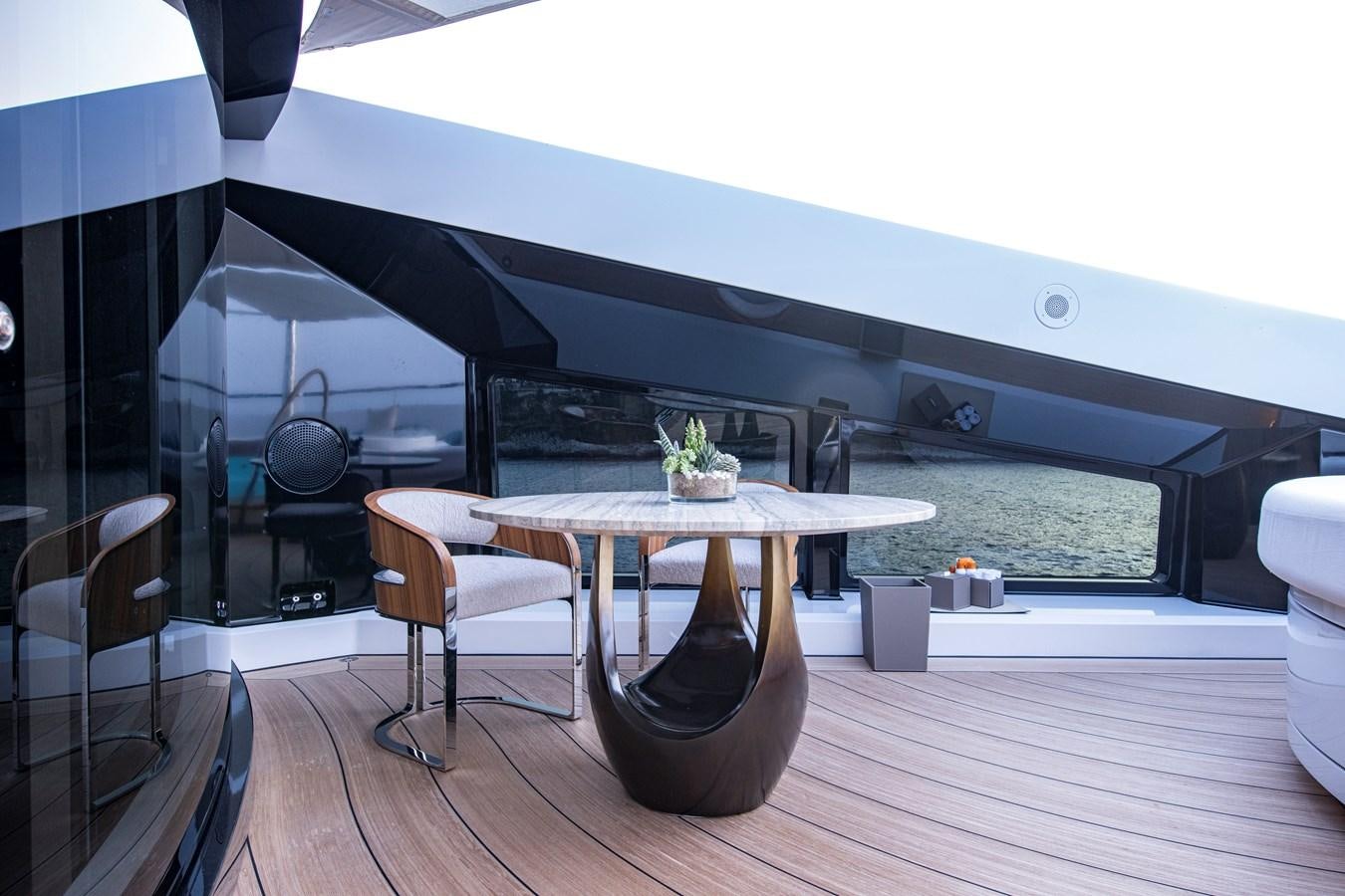 a table with a planter on it aboard LUNA Yacht for Sale