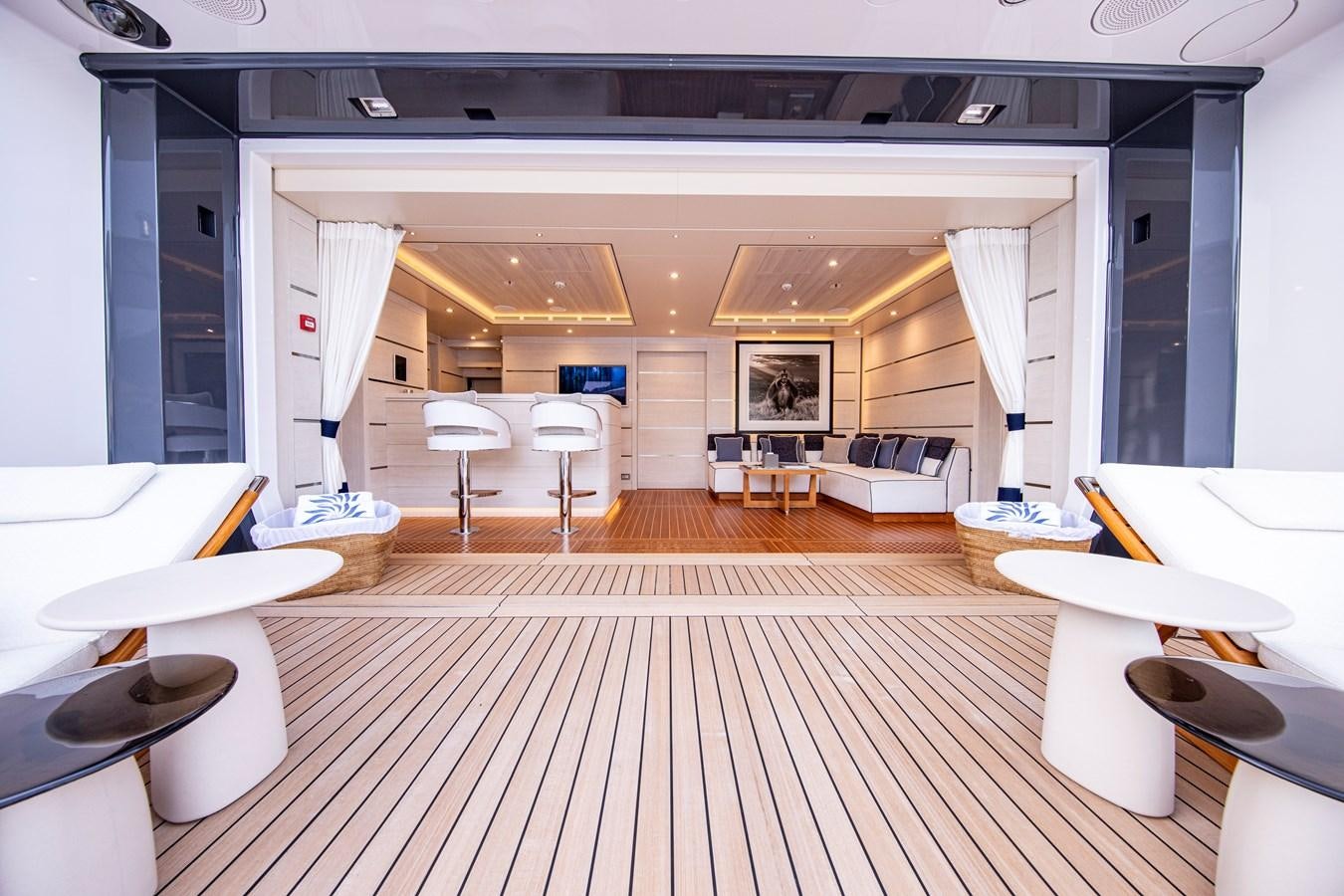 a room with tables and chairs aboard LUNA Yacht for Sale