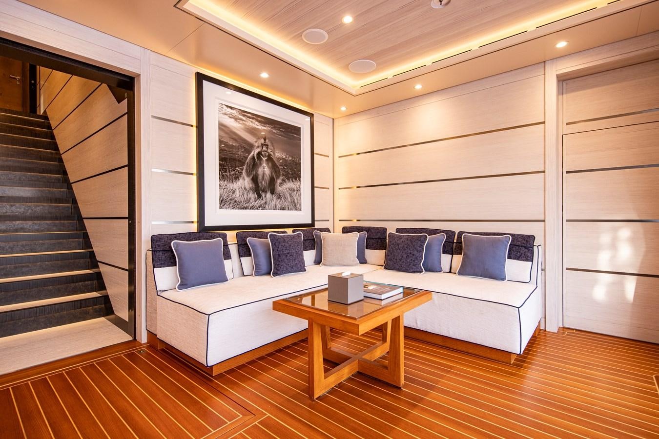a large white couch in a room aboard LUNA Yacht for Sale