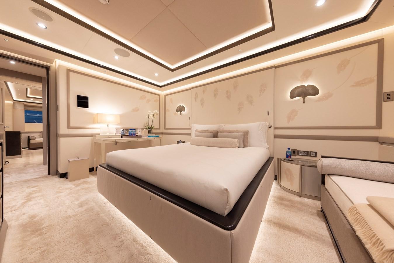 a room with a bed and a desk aboard LUNA Yacht for Sale