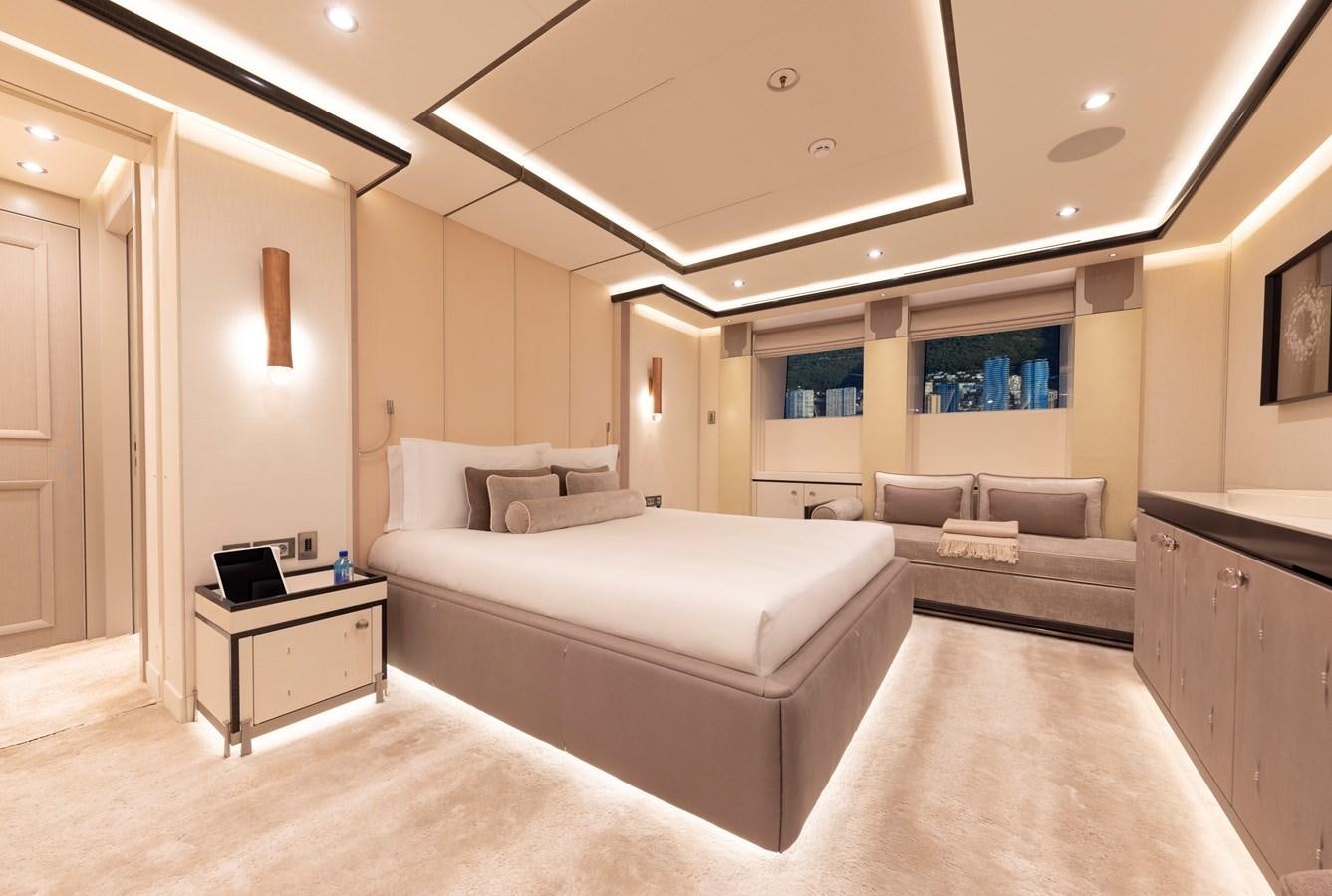 a large bedroom with a bed and a couch aboard LUNA Yacht for Sale