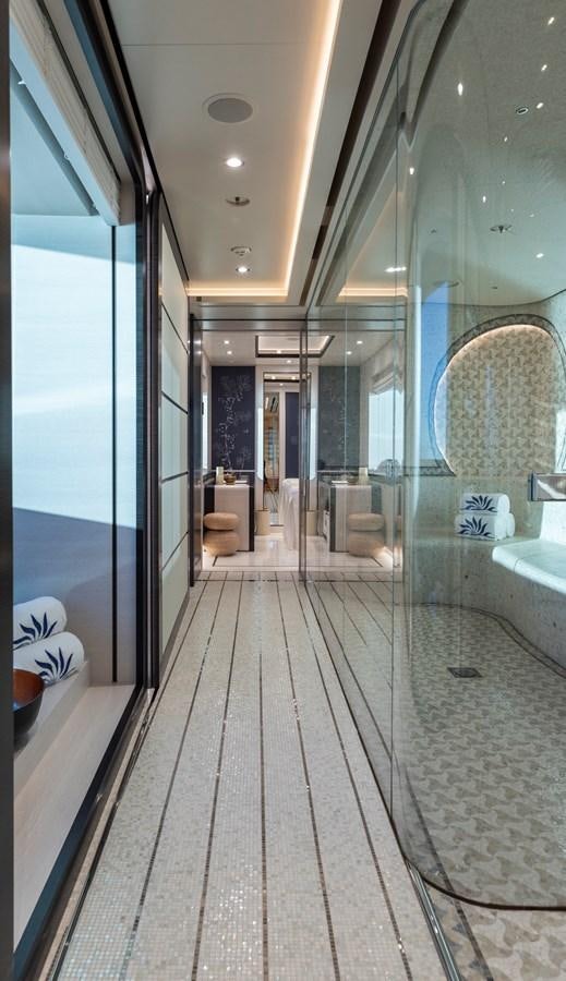 a hallway with glass doors aboard LUNA Yacht for Sale