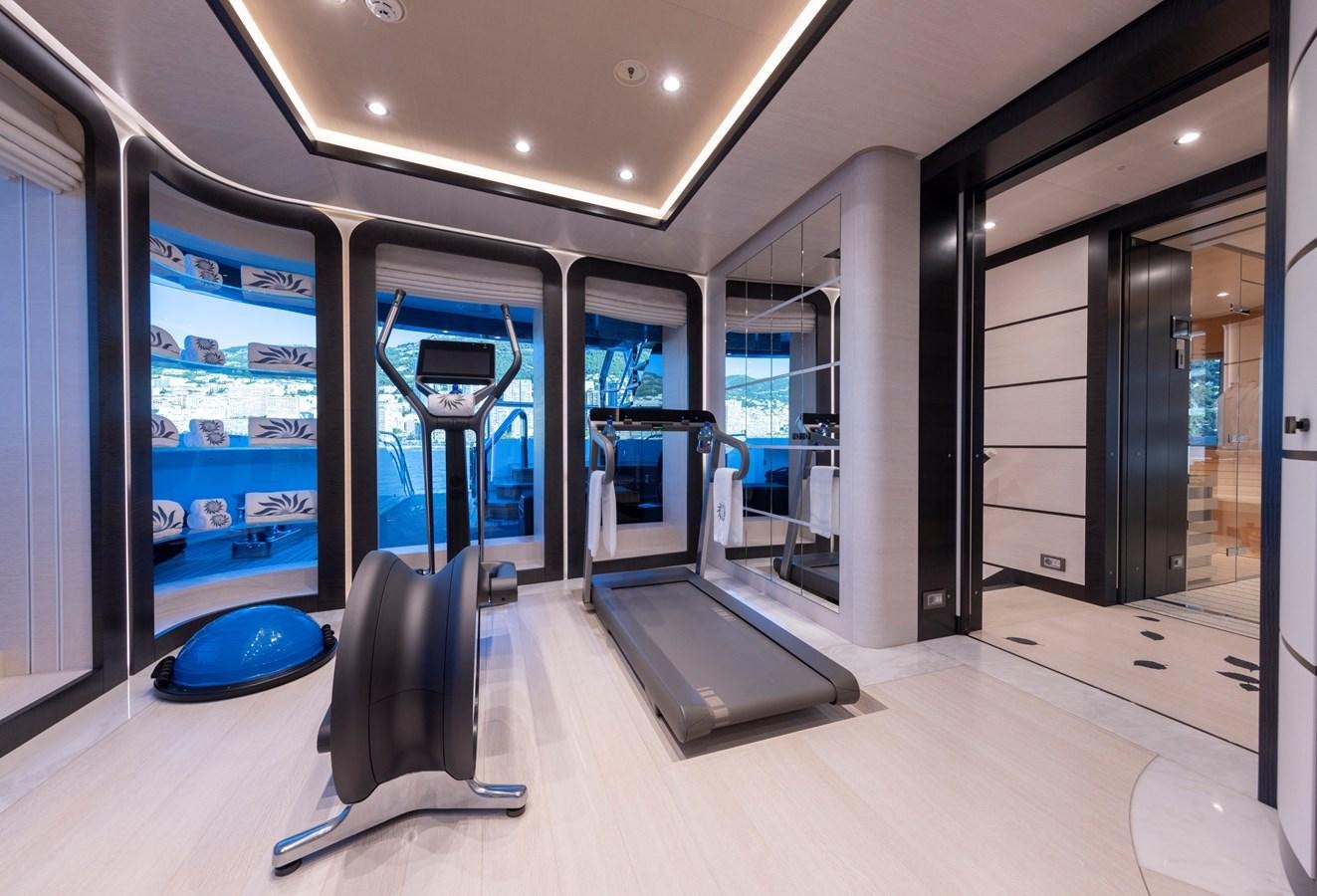a large room with glass walls aboard LUNA Yacht for Sale
