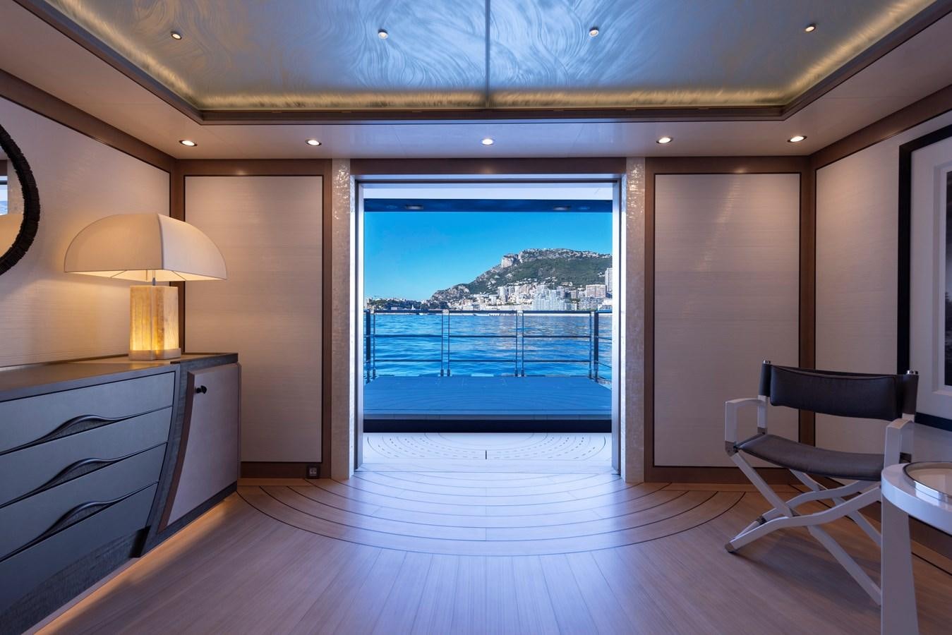 a room with a view of the ocean and a deck aboard LUNA Yacht for Sale