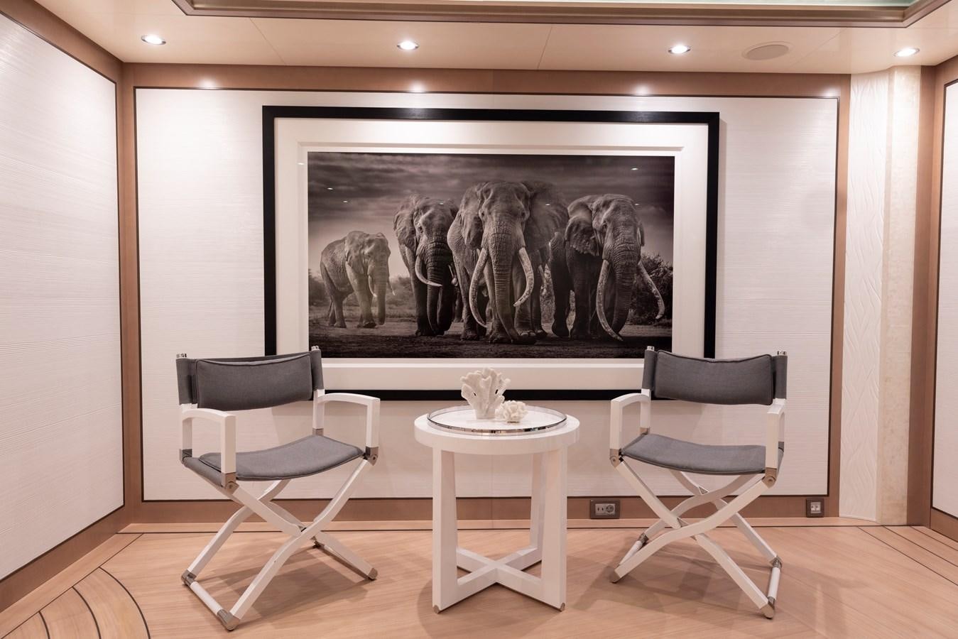 a room with a table and chairs aboard LUNA Yacht for Sale