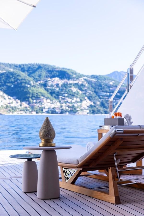 a table with a lamp on it aboard LUNA Yacht for Sale
