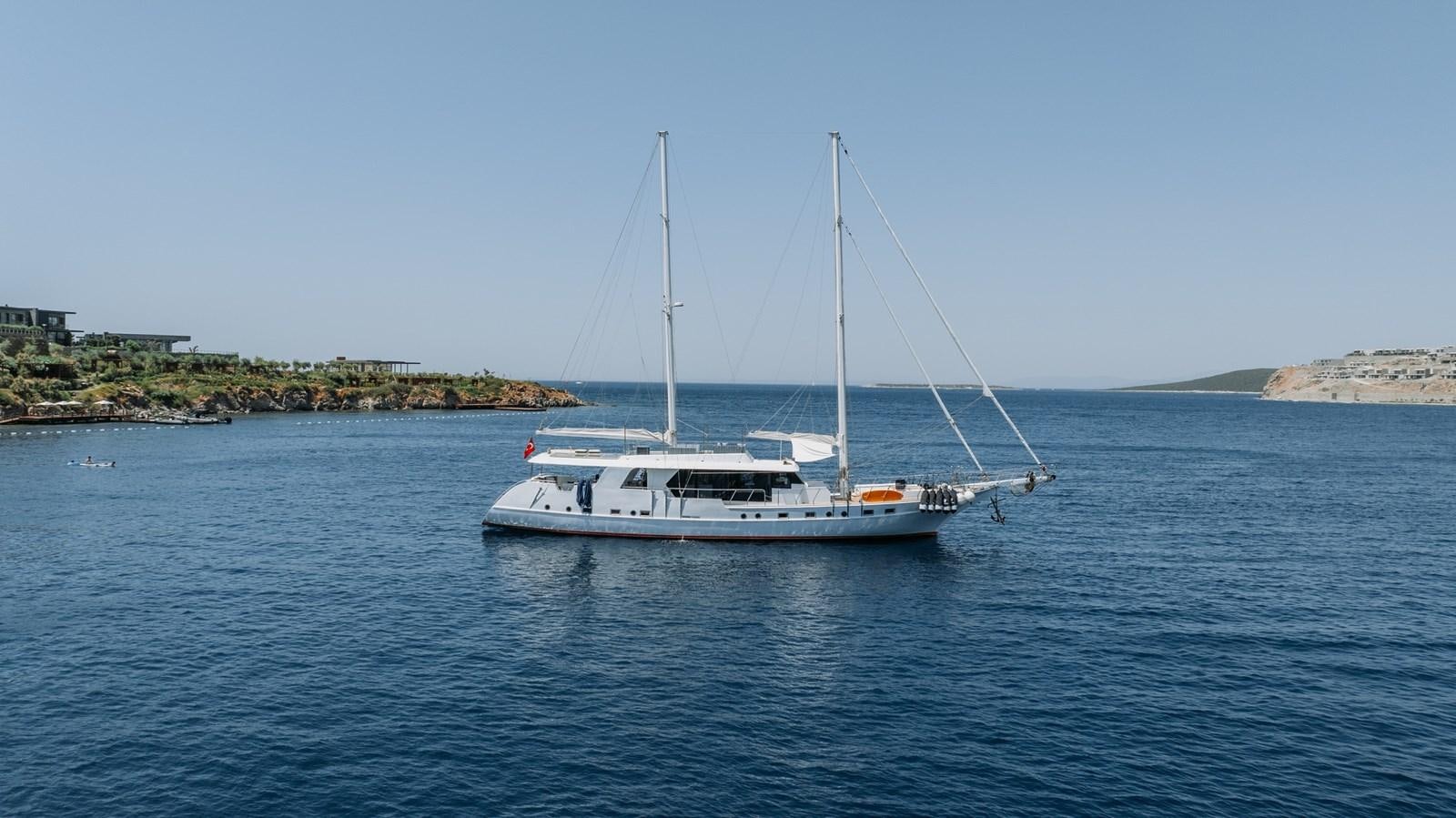 a white boat in the water aboard CUSTOM MADE MOTORSAILER Yacht for Sale