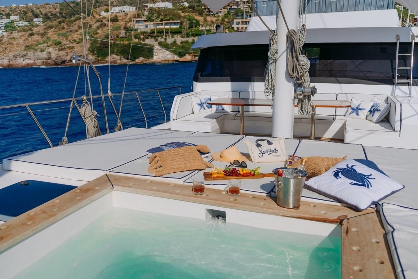 a boat with a tray of food on it aboard CUSTOM MADE MOTORSAILER Yacht for Sale