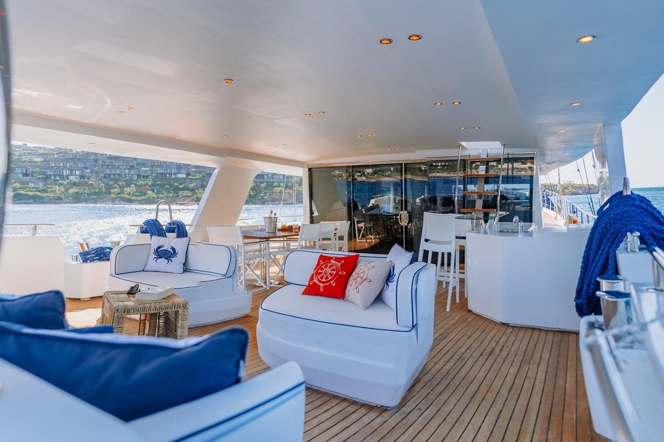 a living room with a large window aboard CUSTOM MADE MOTORSAILER Yacht for Sale