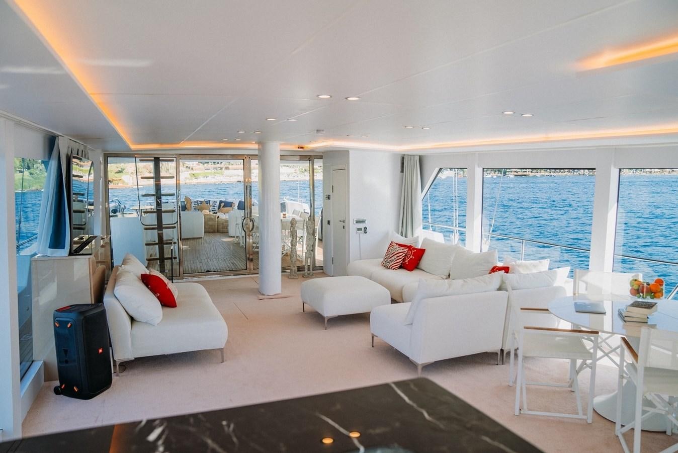 a living room with a large window aboard CUSTOM MADE MOTORSAILER Yacht for Sale