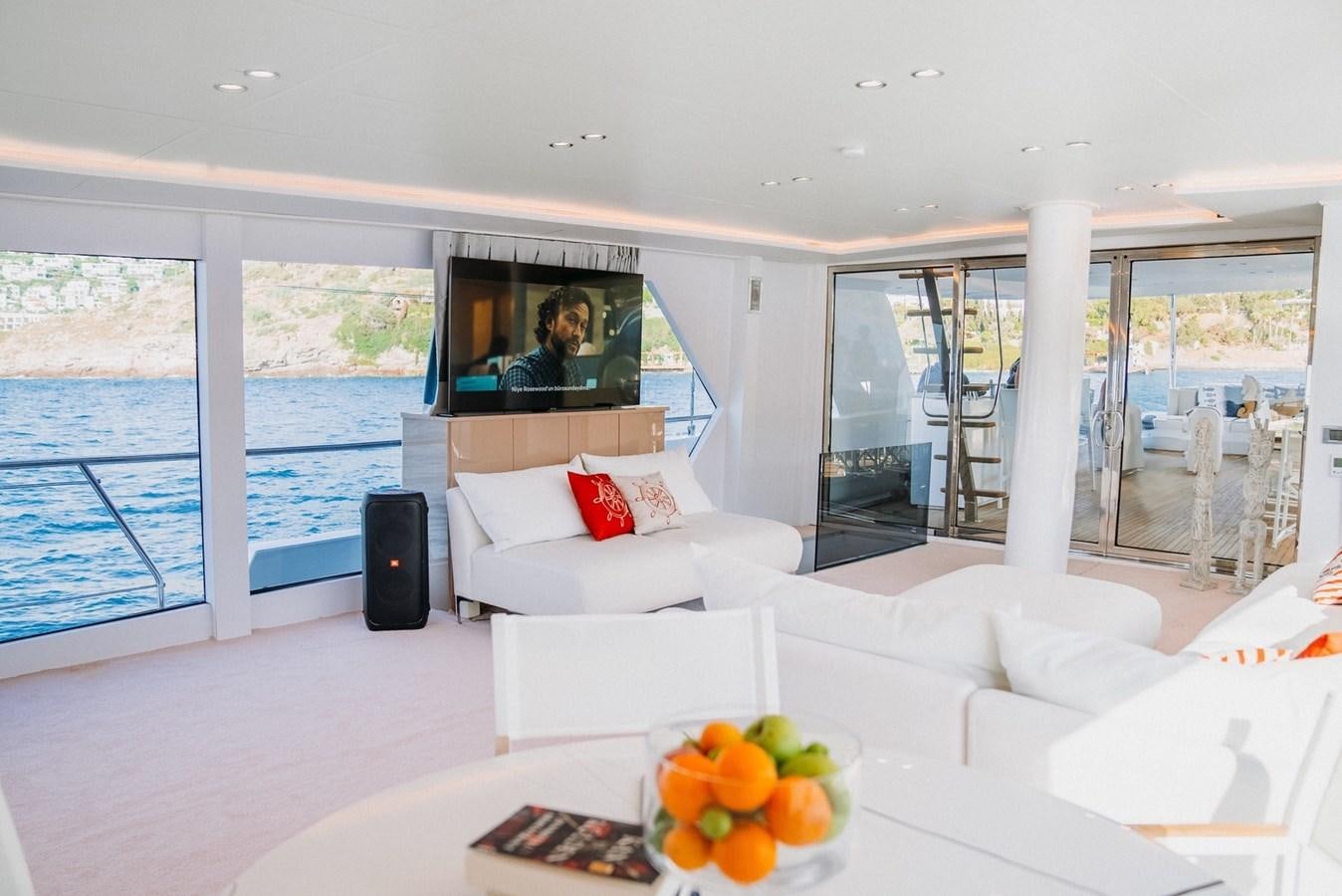 a living room with a large window aboard CUSTOM MADE MOTORSAILER Yacht for Sale
