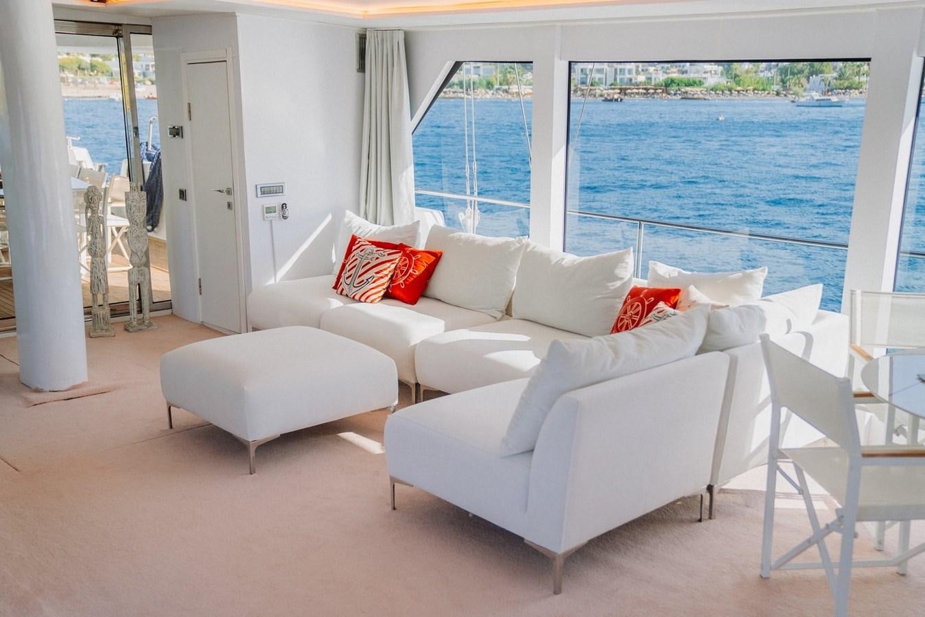 a living room with a large window aboard CUSTOM MADE MOTORSAILER Yacht for Sale