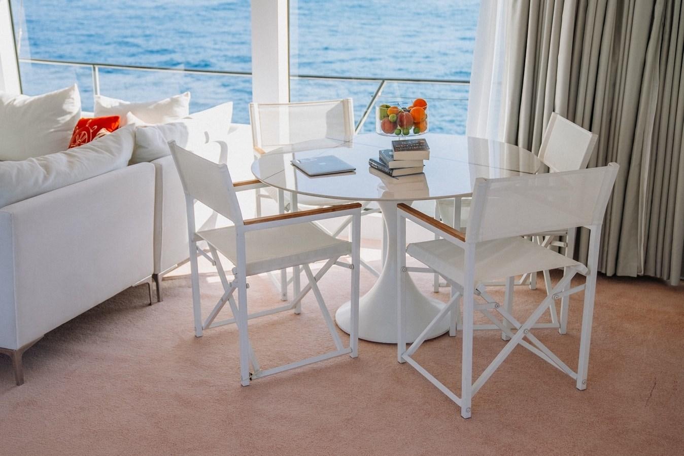 a table and chairs on a beach aboard CUSTOM MADE MOTORSAILER Yacht for Sale