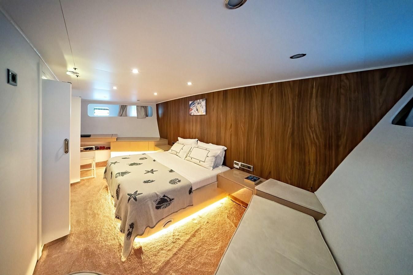 a room with a bed and a wood wall aboard CUSTOM MADE MOTORSAILER Yacht for Sale