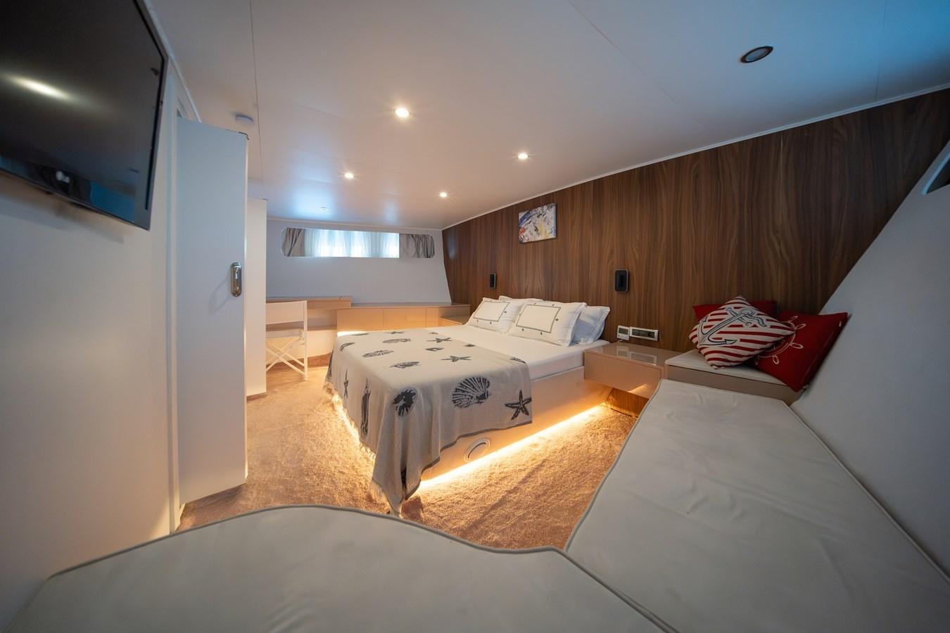 a room with a bed and a tv aboard CUSTOM MADE MOTORSAILER Yacht for Sale