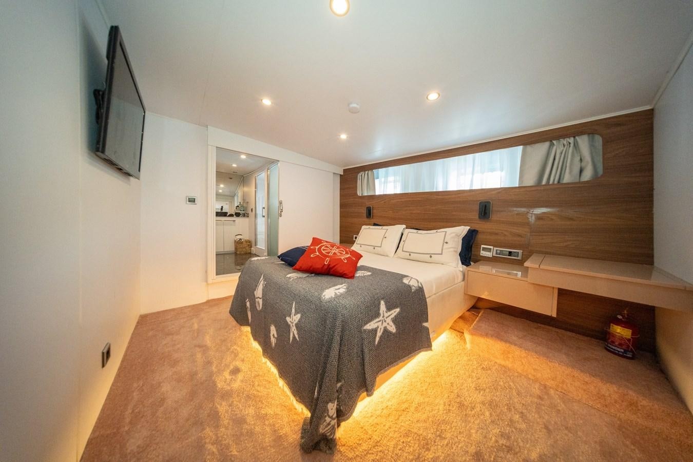 a room with a bed and a television aboard CUSTOM MADE MOTORSAILER Yacht for Sale