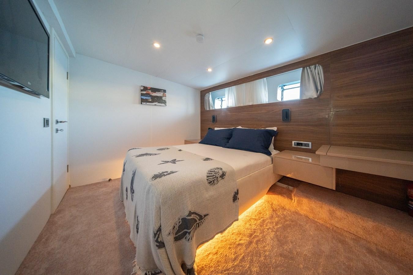 a room with a bed and a wood wall aboard CUSTOM MADE MOTORSAILER Yacht for Sale